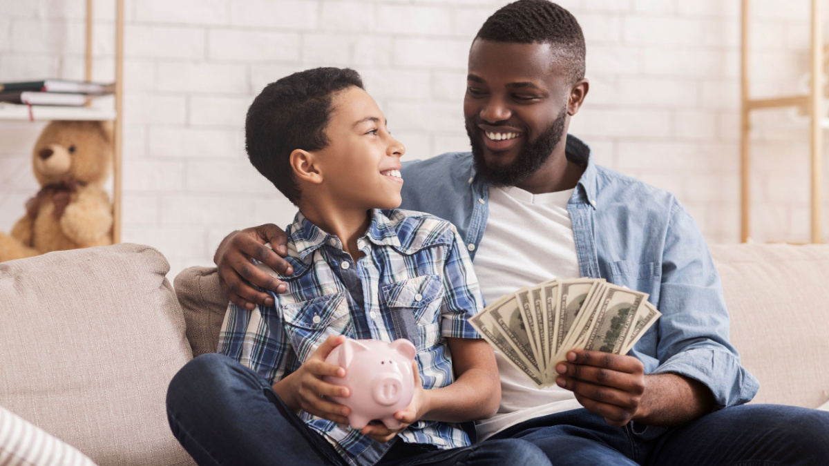 Father and Son saving cash money with a Piggybank